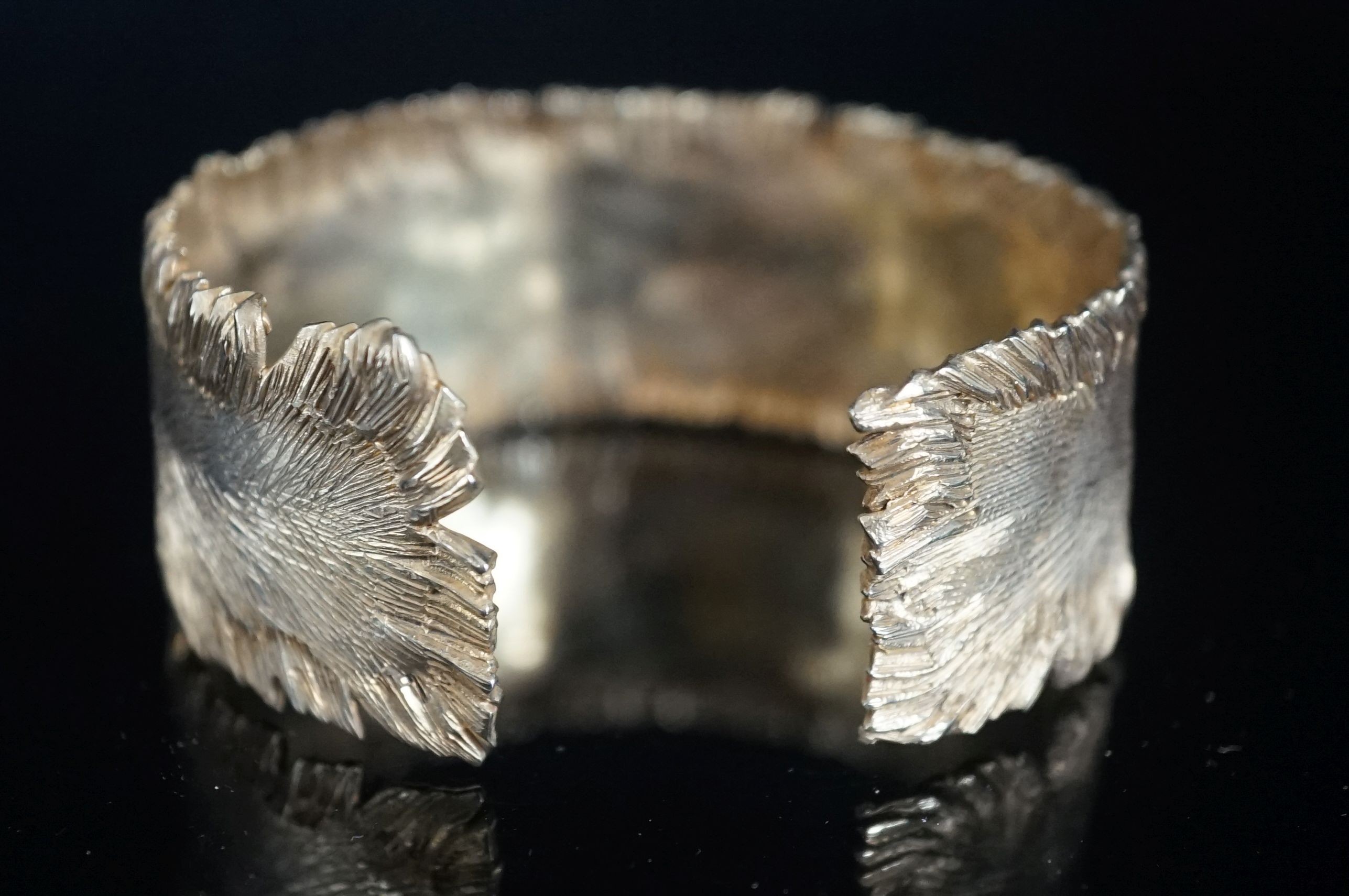 A modern silver gilt open bangle by Adrian Gerald Benney, London, 1962, with samorodok decoration, in original box, interior diameter approx. 60mm, 48 grams.